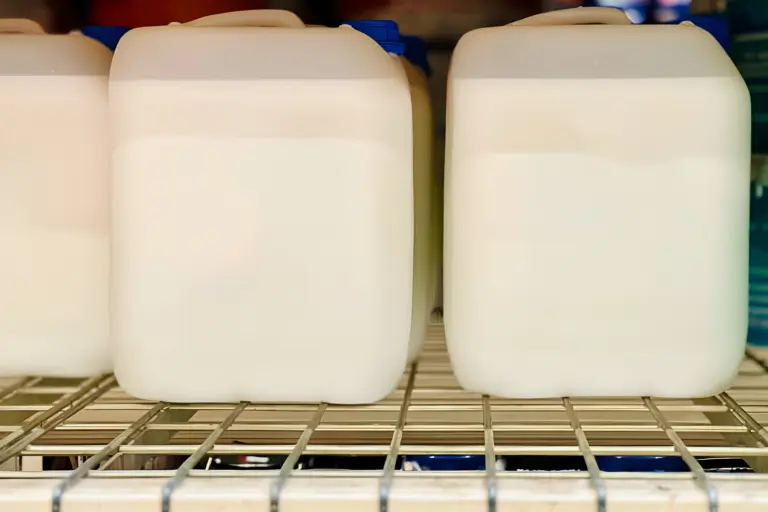 Packaged food-grade PVC stabilizer containers on a warehouse shelf