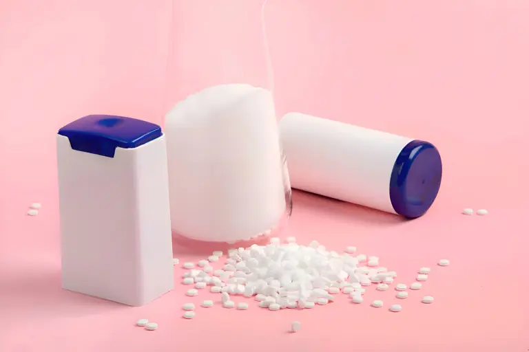 PVC stabilizer granules and beaker representing chemical raw materials