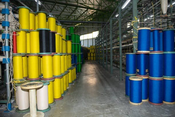 worker applying tin-catalyzed polyester resin coating