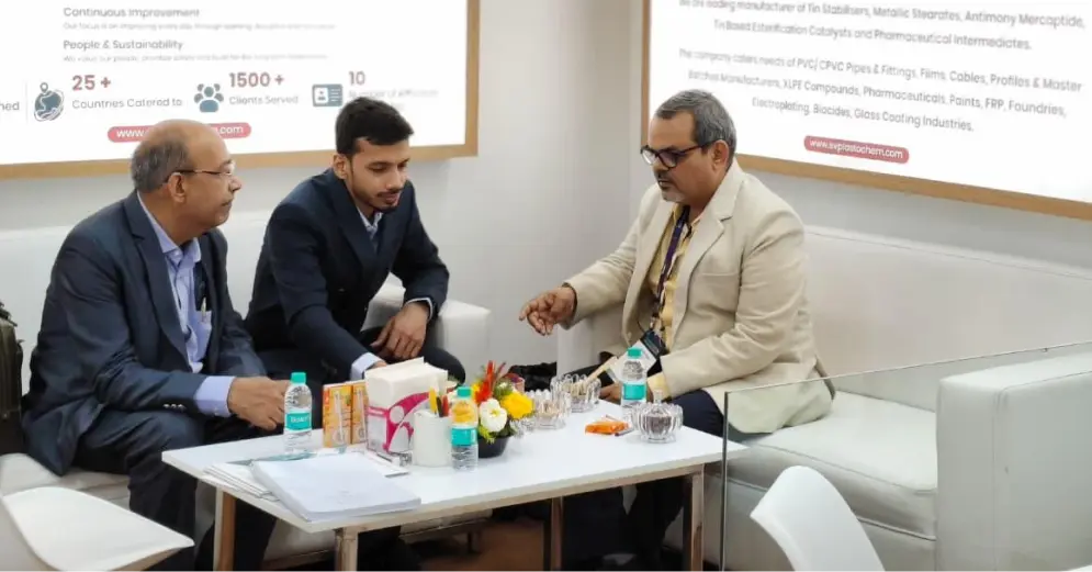 S V Plastochem team in business discussion with industry partner at Plastindia 2026, Bharat Mandapam